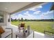 Outdoor patio features ample seating and beautiful green landscape views at 5214 Lake Venice Dr, Wimauma, FL 33598