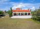 Stunning open-air pavilion featuring a red tile roof, stone columns, and ample seating for gatherings at 5214 Lake Venice Dr, Wimauma, FL 33598