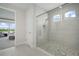 Bright bathroom featuring glass enclosed shower with tile surround and pebble floor at 5214 Lake Venice Dr, Wimauma, FL 33598