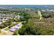 Aerial view of community near Lansbrook Golf Club with lush greenery and ponds at 5460 Millbrook Way, Palm Harbor, FL 34685