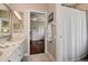 Bright bathroom boasts double sinks, updated fixtures, and an open doorway to a charming bedroom at 5460 Millbrook Way, Palm Harbor, FL 34685