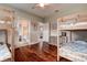 Spacious bedroom features hardwood floors, ceiling fan, and multiple bunk beds with ensuite bathroom at 5460 Millbrook Way, Palm Harbor, FL 34685
