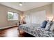 Comfortable bedroom featuring hardwood floors, a window with natural light, and a closet at 5460 Millbrook Way, Palm Harbor, FL 34685