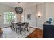 Elegant dining room featuring hardwood floors, modern lighting, and a stylish table setting at 5460 Millbrook Way, Palm Harbor, FL 34685