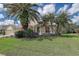 Attractive home featuring lush landscaping, a well-maintained lawn, and a welcoming entrance at 5460 Millbrook Way, Palm Harbor, FL 34685