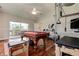 Spacious game room featuring a pool table, exercise equipment, and hardwood floors for recreation and fitness at 5460 Millbrook Way, Palm Harbor, FL 34685