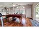 Spacious game room featuring a pool table, large windows, and hardwood floors for entertainment and relaxation at 5460 Millbrook Way, Palm Harbor, FL 34685