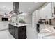 Open-concept kitchen with an island, stainless steel appliances, and views of the dining and living areas at 5460 Millbrook Way, Palm Harbor, FL 34685