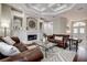 Bright living room featuring custom fireplace, coffered ceiling and neutral paint at 5460 Millbrook Way, Palm Harbor, FL 34685