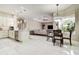 Open-concept kitchen and living area with marble floors and views of a screened patio at 5460 Millbrook Way, Palm Harbor, FL 34685