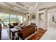 Cozy living room with coffered ceiling, fireplace and view to the backyard at 5460 Millbrook Way, Palm Harbor, FL 34685