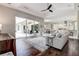 Bright living room with hardwood floors, modern furnishings, and access to a screened patio at 5460 Millbrook Way, Palm Harbor, FL 34685