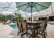 Enclosed pool with outdoor dining area and table seating six in the backyard at 5460 Millbrook Way, Palm Harbor, FL 34685
