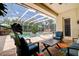 Enclosed pool with outdoor seating in the beautiful backyard at 5460 Millbrook Way, Palm Harbor, FL 34685