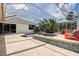 Enclosed pool with bar seating and outdoor seating in the beautiful backyard at 5460 Millbrook Way, Palm Harbor, FL 34685