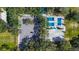 Aerial view of well-maintained tennis courts, parking, and lush landscaping in a vibrant community setting at 5460 Millbrook Way, Palm Harbor, FL 34685