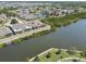 Aerial view of homes nestled by a tranquil lake, showcasing a serene community at 5702 Tides Pl, Apollo Beach, FL 33572