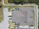 Aerial view of the home showcasing the roof, driveway, screened-in lanai, and surrounding landscaping at 5702 Tides Pl, Apollo Beach, FL 33572