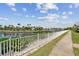 Scenic backyard view overlooking a tranquil canal with lush landscaping and waterfront homes in the distance at 5702 Tides Pl, Apollo Beach, FL 33572