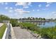 Scenic backyard view overlooking a tranquil canal with lush landscaping and waterfront homes at 5702 Tides Pl, Apollo Beach, FL 33572
