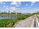 Scenic backyard view overlooking a tranquil canal with lush landscaping and waterfront homes at 5702 Tides Pl, Apollo Beach, FL 33572