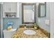 Updated bathroom with granite countertop, basin sink, decor, and framed mirror at 5702 Tides Pl, Apollo Beach, FL 33572