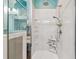 Modern bathroom with a shower featuring a glass door, storage shelves, and nautical decorations at 5702 Tides Pl, Apollo Beach, FL 33572