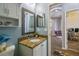 Bathroom features a granite countertop, updated vanity, and framed mirror, creating a stylish and functional space at 5702 Tides Pl, Apollo Beach, FL 33572