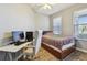 Cozy bedroom featuring a desk, gaming setup, and wood floors at 5702 Tides Pl, Apollo Beach, FL 33572