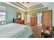 Warm bedroom with wood floors, ceiling detail, and natural light at 5702 Tides Pl, Apollo Beach, FL 33572