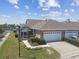 Charming home featuring a screened lanai, two-car garage, landscaped yard, and serene canal views at 5702 Tides Pl, Apollo Beach, FL 33572