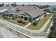 Charming home featuring a screened porch, well-manicured lawn, and a lovely garden at 5702 Tides Pl, Apollo Beach, FL 33572