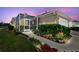 Charming home featuring a screened lanai surrounded by lush greenery and a beautiful walkway at 5702 Tides Pl, Apollo Beach, FL 33572