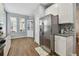 Bright kitchen featuring stainless steel appliances, wood-look flooring, white cabinets, and granite countertops at 5702 Tides Pl, Apollo Beach, FL 33572