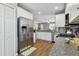 Open kitchen design with stainless steel refrigerator and appliances, granite countertops, and white cabinetry at 5702 Tides Pl, Apollo Beach, FL 33572