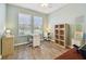 Bright office space with two windows, neutral walls, and stylish laminate floors at 5702 Tides Pl, Apollo Beach, FL 33572