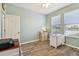 Bright office featuring laminate floors, light green walls, and a view of the outdoors at 5702 Tides Pl, Apollo Beach, FL 33572