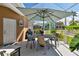 Enjoy outdoor dining on the covered patio, complete with a table, chairs, and serene views at 5702 Tides Pl, Apollo Beach, FL 33572