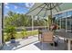 Enjoy views of the landscaped yard from the screened patio, complete with outdoor dining area and lush greenery at 5702 Tides Pl, Apollo Beach, FL 33572