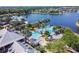Overhead view of a luxury pool with a lazy river, water slide, palm trees and docks on a lake at 5702 Tides Pl, Apollo Beach, FL 33572