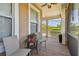 Cozy screened-in porch with comfortable seating, ceiling fan, and views of the outdoors at 5702 Tides Pl, Apollo Beach, FL 33572