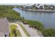Picturesque waterfront property with a lush green lawn and serene canal views at 5702 Tides Pl, Apollo Beach, FL 33572