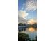 Scenic waterfront view reflecting the sky, with docks and lush greenery under a bright sky at 5702 Tides Pl, Apollo Beach, FL 33572