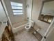 Bathroom features a tub, toilet, sink, and a mirror, awaiting full renovation and remodeling at 6609 Sierra Ter, New Port Richey, FL 34652