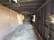 Spacious garage with visible wall studs and concrete floor, awaiting restoration at 6609 Sierra Ter, New Port Richey, FL 34652