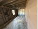 Spacious garage with visible wall studs and concrete floor, ready for restoration at 6609 Sierra Ter, New Port Richey, FL 34652