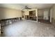 Spacious living room with tiled floors and open to the kitchen needing renovation at 6609 Sierra Ter, New Port Richey, FL 34652
