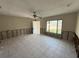 Inviting living room with open door, tiled floors, needing renovation at 6609 Sierra Ter, New Port Richey, FL 34652