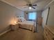 Cozy bedroom with ceiling fan, white furnishings, and tile flooring at 605 Brandy Wine Dr # 605, Largo, FL 33771