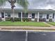 Street view of condos with well-maintained lawns and charming brick-accented facades at 605 Brandy Wine Dr # 605, Largo, FL 33771